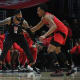Los Angeles Clippers forward Marcus Morris Sr. (8) controls the ball against Toronto Raptors forward Scottie Barnes (4) during the second half at Crypto.com Arena